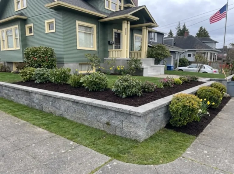 Finished block retaining wall with a replanted slope above