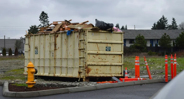 Roll-off dumpster loaded with old lumber and debris